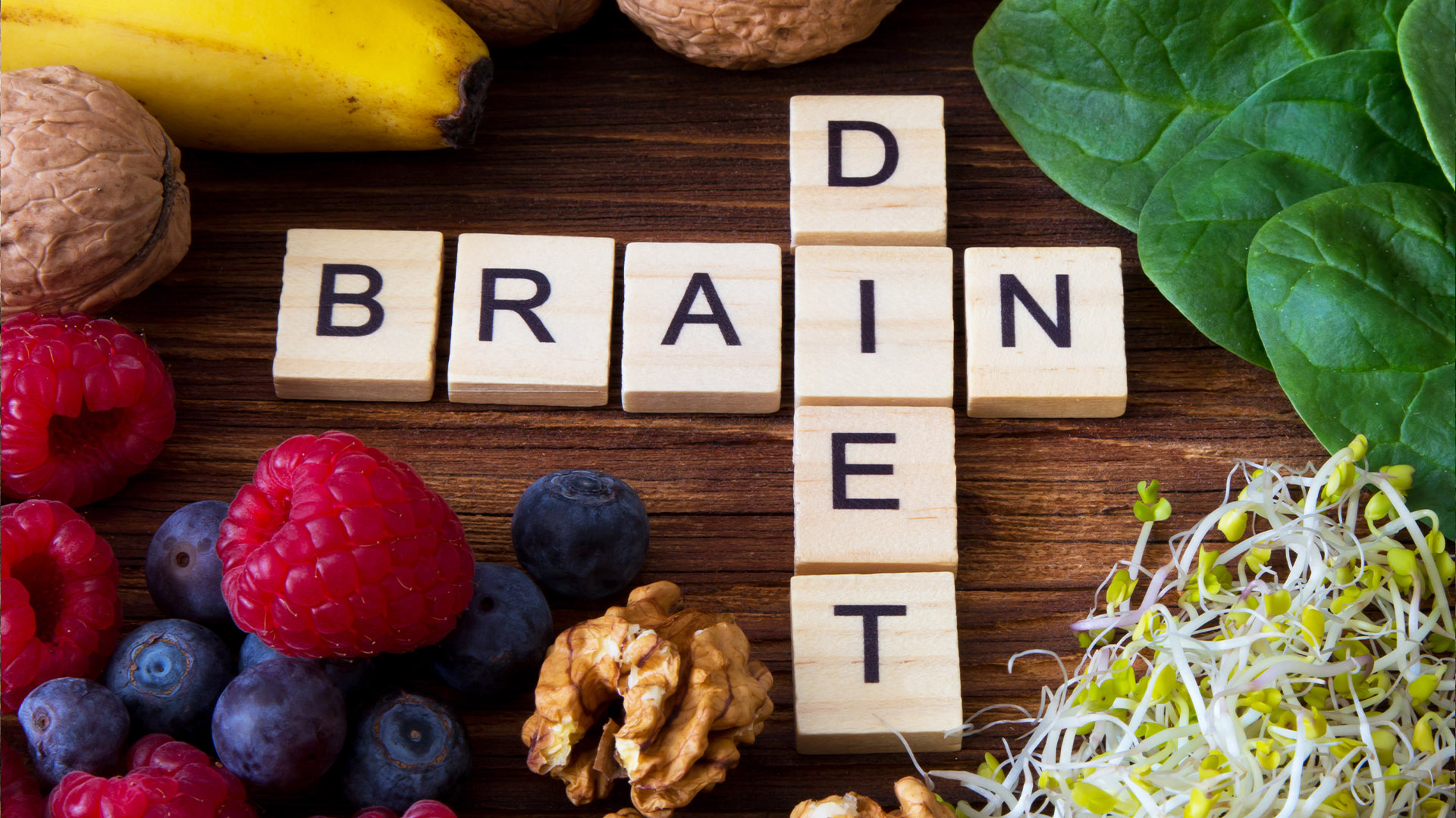 Wooden tiles with letters saying Diet and Brain laying on the table among fruits
